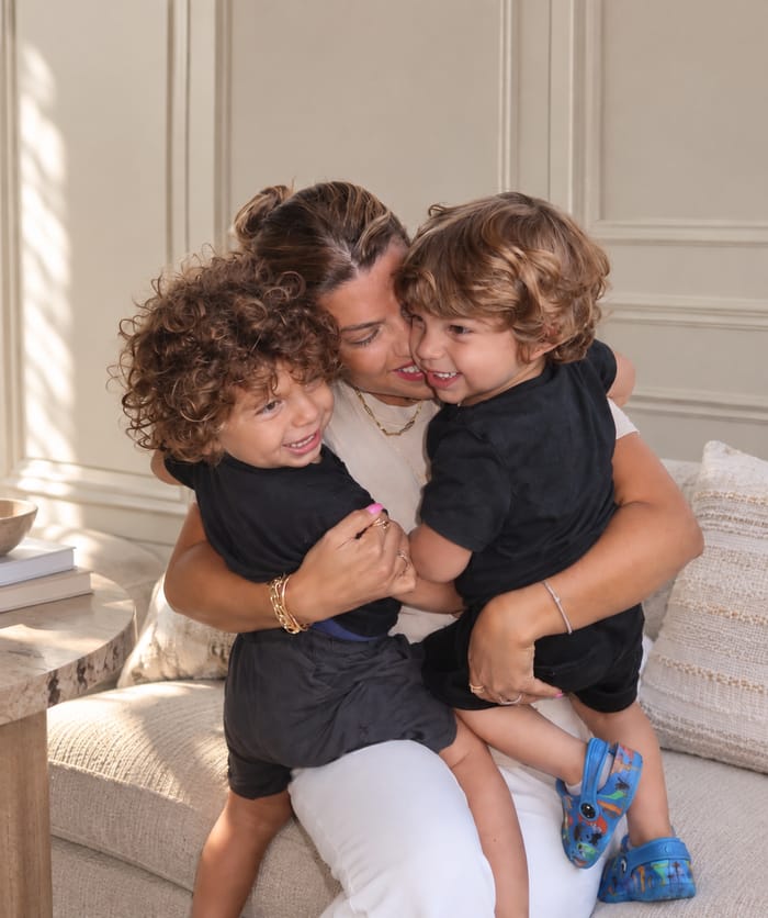 Shahera hugging her two young sons.